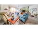 Bright and airy living room with carpet floors, comfortable seating, and a ceiling fan at 19427 N 84Th Ave, Peoria, AZ 85382