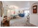 Inviting living room and dining area with carpet flooring, chandelier, and abundant natural light at 19427 N 84Th Ave, Peoria, AZ 85382