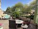 Inviting outdoor patio with a gas fire pit, seating, and desert landscaping offering beautiful views at 19427 N 84Th Ave, Peoria, AZ 85382