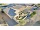Aerial view of a home with a tile roof, desert landscaping, and a covered patio area at 20044 N London Bridge Dr, Surprise, AZ 85387