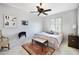 Cozy bedroom with a comfortable bed, ceiling fan, and natural light from the window at 20044 N London Bridge Dr, Surprise, AZ 85387