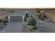 Attractive home exterior with desert landscaping, a three-car garage, and a stone facade at 20044 N London Bridge Dr, Surprise, AZ 85387