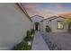 Charming home exterior featuring desert landscaping, stone accents, and a covered entryway at 20044 N London Bridge Dr, Surprise, AZ 85387