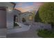 Charming home exterior featuring desert landscaping, stone accents, and a covered entryway at 20044 N London Bridge Dr, Surprise, AZ 85387