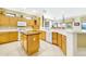 Bright kitchen with white countertops, light wood cabinets, stainless steel appliances, and a center island at 20044 N London Bridge Dr, Surprise, AZ 85387