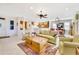 Bright open living room with tile flooring and an open floorplan into the kitchen and dining area at 20044 N London Bridge Dr, Surprise, AZ 85387