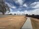 Expansive backyard featuring block fencing, landscaping opportunities, and a concrete walkway for easy access at 2018 W Western Dr, Chandler, AZ 85224