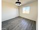 Bright bedroom with large closet, a view to the backyard, and luxury vinyl plank flooring at 2018 W Western Dr, Chandler, AZ 85224