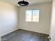 Bedroom featuring modern light fixture, luxury vinyl plank flooring, and lots of natural light at 2018 W Western Dr, Chandler, AZ 85224
