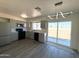 An open kitchen features stainless steel appliances, grey cabinets and a sliding glass door to the outside patio at 2018 W Western Dr, Chandler, AZ 85224