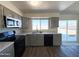 A well-lit kitchen features stainless steel appliances and countertops with a view to the backyard at 2018 W Western Dr, Chandler, AZ 85224