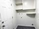 Clean laundry room featuring white walls, cabinets, utility hookups, and vinyl flooring at 2018 W Western Dr, Chandler, AZ 85224