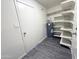 Bright storage room featuring a water heater, white shelving, and wood-look floors at 2018 W Western Dr, Chandler, AZ 85224