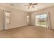 Spacious main bedroom with a ceiling fan and sliding glass door to the backyard at 21333 N Denton Dr, Maricopa, AZ 85138