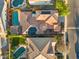 An aerial view showing a tile roof, backyard pools, desert landscaping, and solar panels at 2134 E Honeysuckle Pl, Chandler, AZ 85286