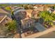 Aerial view of a desert home showcasing a tile roof, solar panels, and desert landscaping at 2134 E Honeysuckle Pl, Chandler, AZ 85286