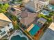 Aerial view of a home with a pool and spa, desert landscaped yard, and tile roof at 2134 E Honeysuckle Pl, Chandler, AZ 85286