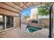 Outdoor living space featuring fireplace, water feature and covered patio at 2134 E Honeysuckle Pl, Chandler, AZ 85286