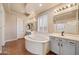 Luxurious bathroom with dual vanities, separate shower, and jetted tub at 2134 E Honeysuckle Pl, Chandler, AZ 85286