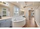 Bright bathroom features a soaking tub and double vanities at 2134 E Honeysuckle Pl, Chandler, AZ 85286