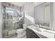 Modern bathroom boasts a tiled shower with glass door and stone-look floors at 2134 E Honeysuckle Pl, Chandler, AZ 85286