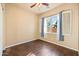 Bright bedroom featuring hardwood floors, a ceiling fan and a window with shutter blinds at 2134 E Honeysuckle Pl, Chandler, AZ 85286