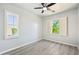 A bright bedroom features shuttered windows and ceiling fan, creating a comfortable space at 2134 E Honeysuckle Pl, Chandler, AZ 85286