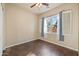 Bright bedroom with wood-look flooring, a ceiling fan, and a window at 2134 E Honeysuckle Pl, Chandler, AZ 85286