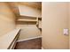Walk-in closet with wooden floors and multiple shelves for storage at 2134 E Honeysuckle Pl, Chandler, AZ 85286