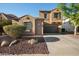 Charming stucco home featuring a well-manicured yard and a two-car garage at 2134 E Honeysuckle Pl, Chandler, AZ 85286