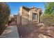 Home's front yard with desert landscaping, walkway, and secure iron gate at 2134 E Honeysuckle Pl, Chandler, AZ 85286