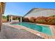 This spacious backyard features a pool, cabana, and lush green landscaping at 2134 E Honeysuckle Pl, Chandler, AZ 85286