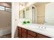 Bathroom with tile floors, cherry wood cabinets and a white counter, including shower and bathtub at 2453 E Ebony Dr, Chandler, AZ 85286
