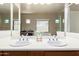 Bright bathroom featuring dual sinks with large mirrors and ample natural light at 2453 E Ebony Dr, Chandler, AZ 85286