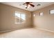 Bedroom with neutral carpet and walls, three windows providing natural light, and ceiling fan at 2453 E Ebony Dr, Chandler, AZ 85286