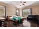 Spacious bedroom features a ceiling fan, hardwood floors, and a comfortable seating area at 2453 E Ebony Dr, Chandler, AZ 85286