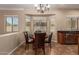 Elegant dining area with natural lighting, wood flooring, and stylish furniture at 2453 E Ebony Dr, Chandler, AZ 85286