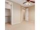 Large empty room with neutral carpet, including a walk-in closet and a view of the staircase at 2453 E Ebony Dr, Chandler, AZ 85286