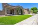 Inviting home with porte-cochere, manicured lawn, desert landscaping, and neutral paint at 2453 E Ebony Dr, Chandler, AZ 85286