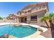 Exterior view of home featuring a backyard pool, covered patio, and mature landscaping at 2453 E Ebony Dr, Chandler, AZ 85286