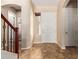 Open foyer with tile floor, staircase with decorative wrought iron, and view to living area at 2453 E Ebony Dr, Chandler, AZ 85286