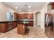 Charming kitchen boasting wood cabinets, stainless steel appliances, and a functional center island at 2453 E Ebony Dr, Chandler, AZ 85286