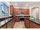 Well-equipped kitchen with dark granite counters, stainless steel appliances and wood cabinetry at 2453 E Ebony Dr, Chandler, AZ 85286