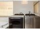 Modern laundry area featuring side by side Samsung washer and dryer and a soaking tub at 2453 E Ebony Dr, Chandler, AZ 85286