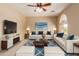 Bright living room featuring a ceiling fan, stylish furniture, and a modern blue rug at 2453 E Ebony Dr, Chandler, AZ 85286
