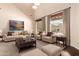 Staged living room with neutral decor, hardwood floors, and view of the backyard pool at 2453 E Ebony Dr, Chandler, AZ 85286