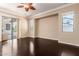 Spacious living room featuring hardwood floors, large windows and a ceiling fan at 2453 E Ebony Dr, Chandler, AZ 85286