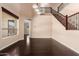 Spacious room with wood floors, neutral paint, a staircase, and a view to the outdoors at 2453 E Ebony Dr, Chandler, AZ 85286