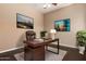 Home office featuring a modern desk, leather chair, and natural light at 2453 E Ebony Dr, Chandler, AZ 85286