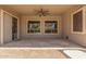 Covered patio featuring tile and stone floors, ceiling fan, and offering outdoor lounging at 2453 E Ebony Dr, Chandler, AZ 85286